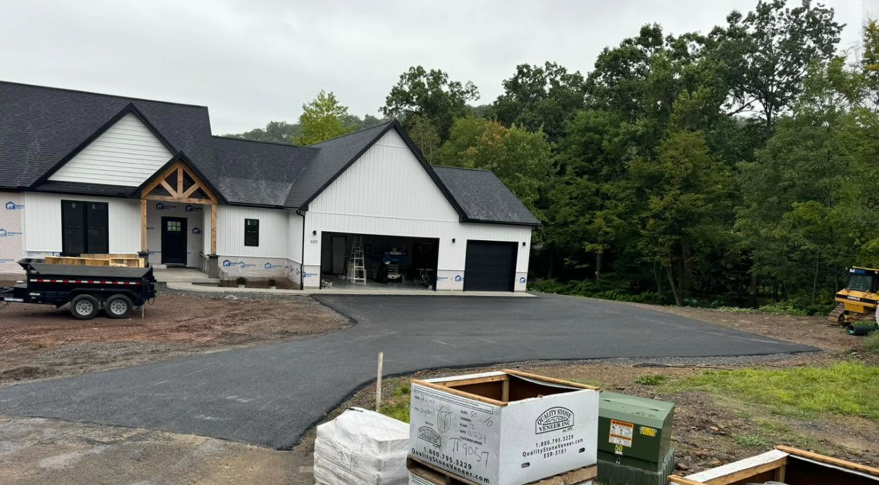 Modern farmhouse under construction driveway